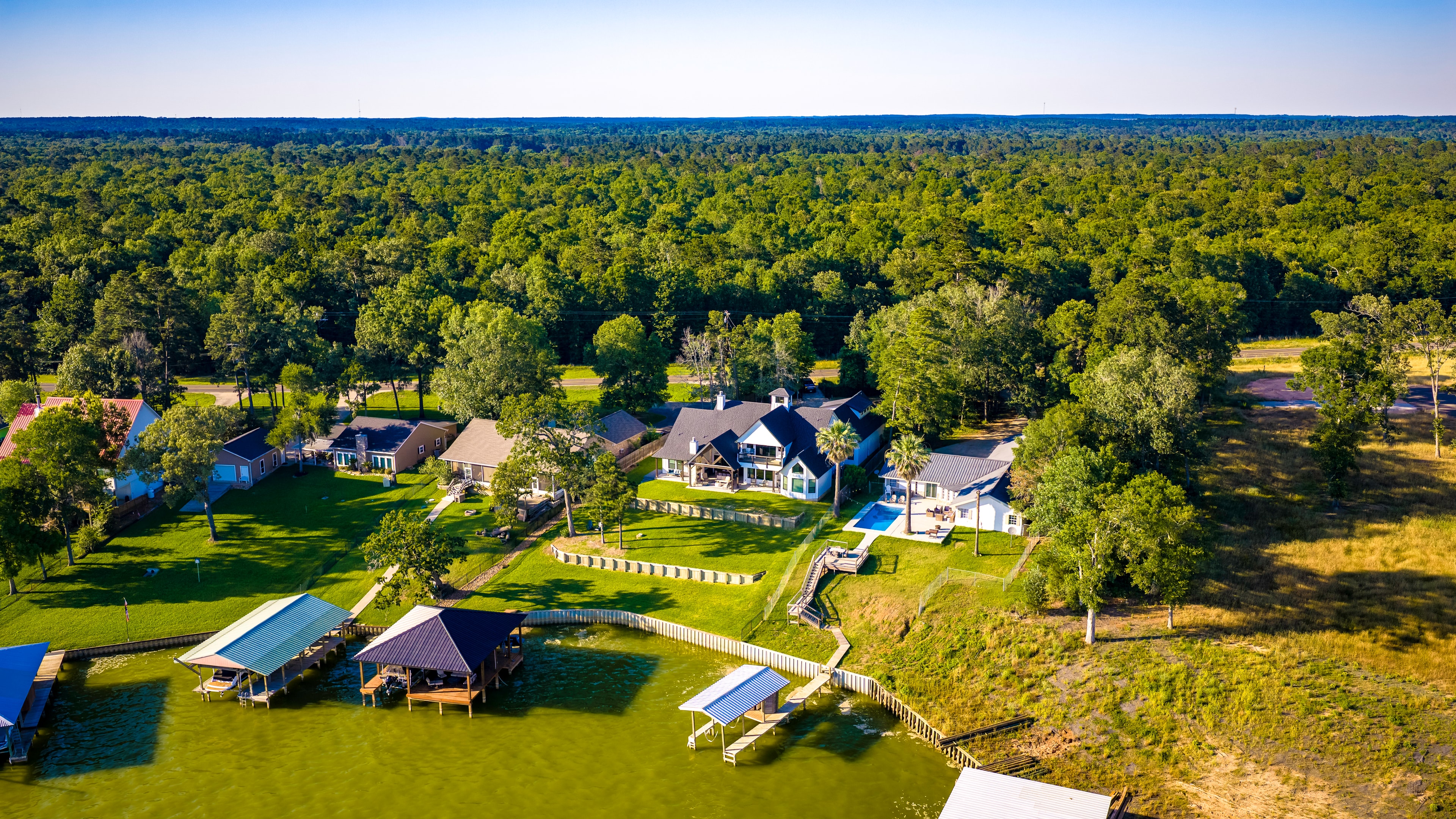 Aerial view of waterfront homes and forest