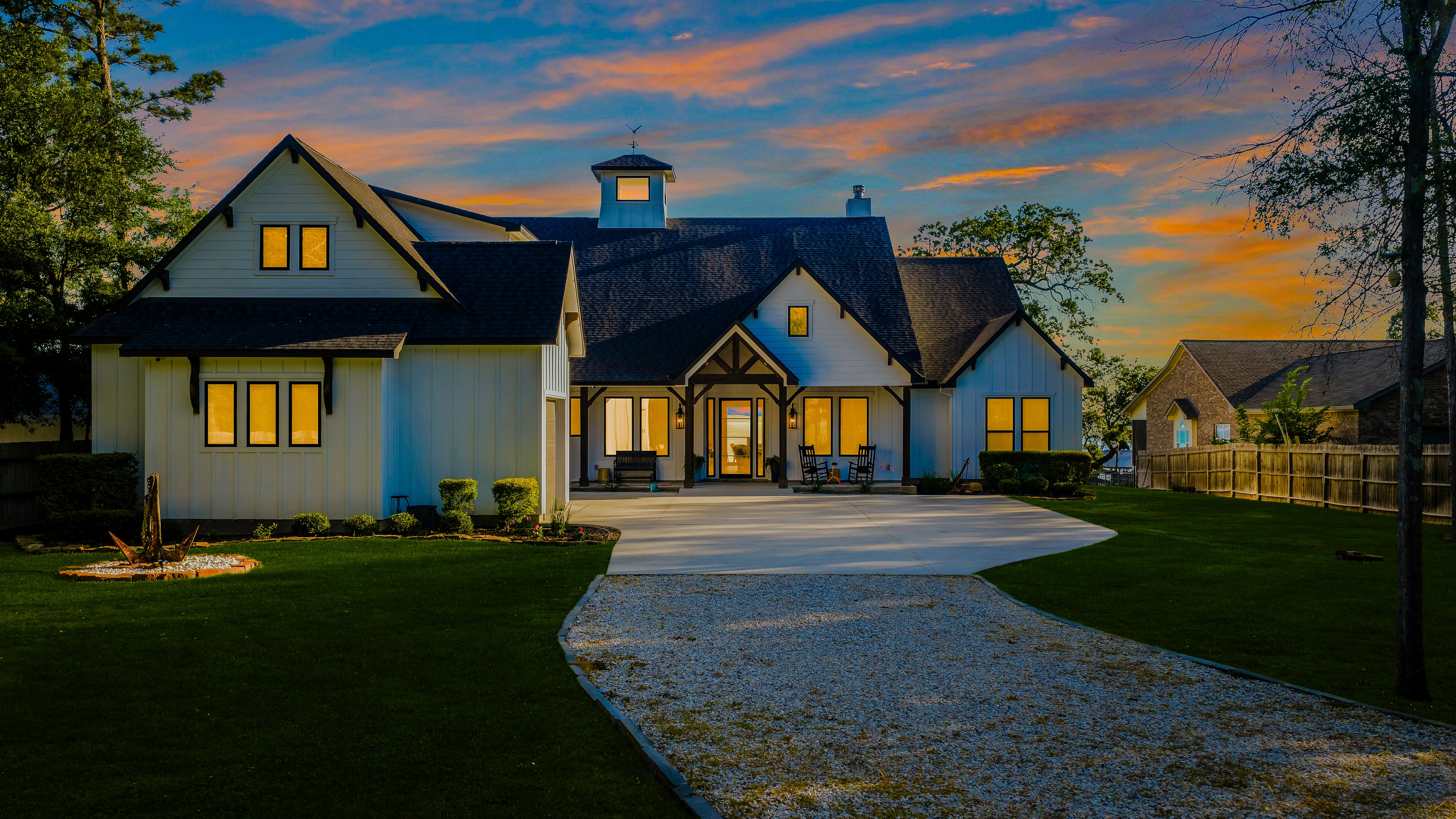 Modern farmhouse glowing at dusk