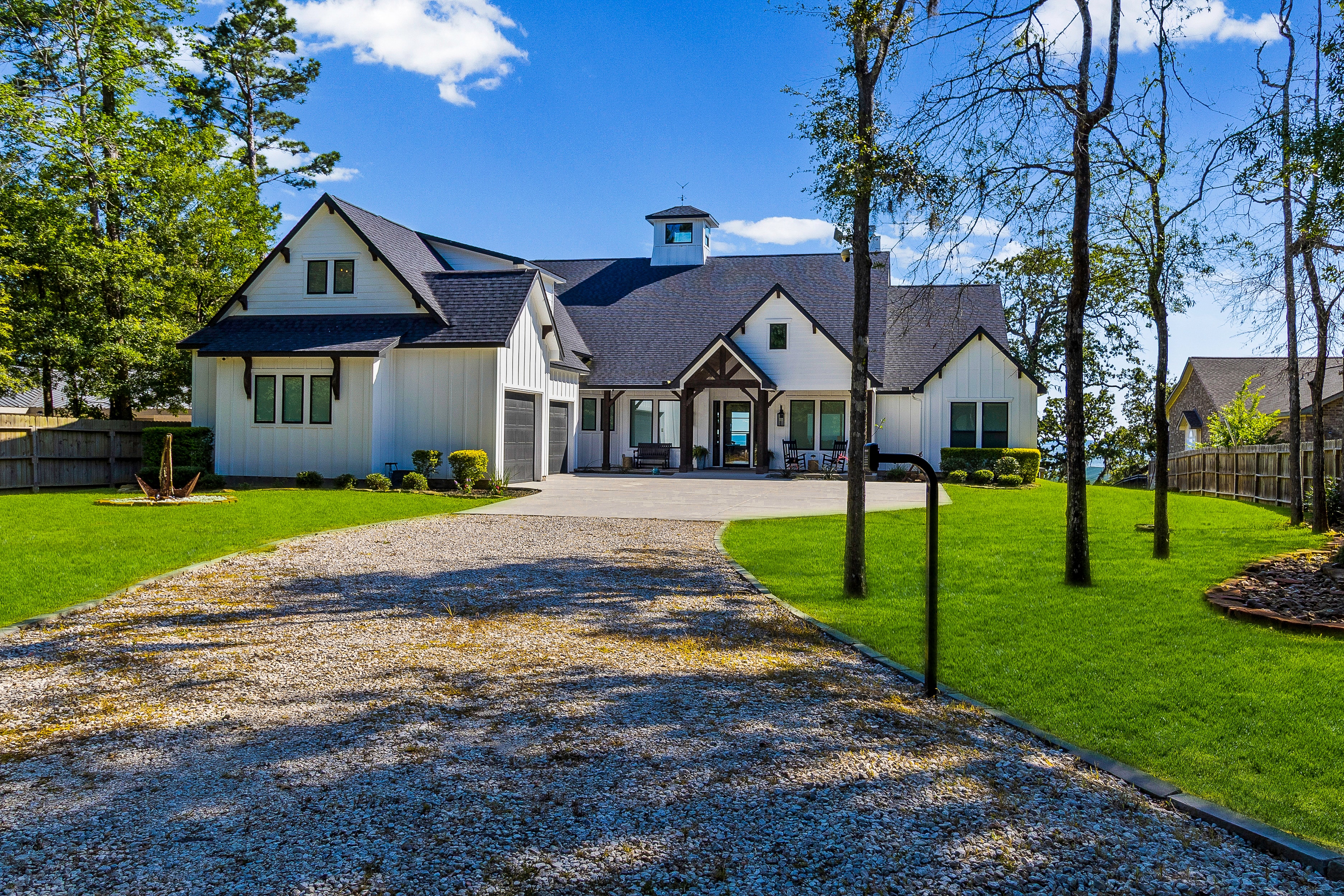 Exterior with gravel driveway and mature trees