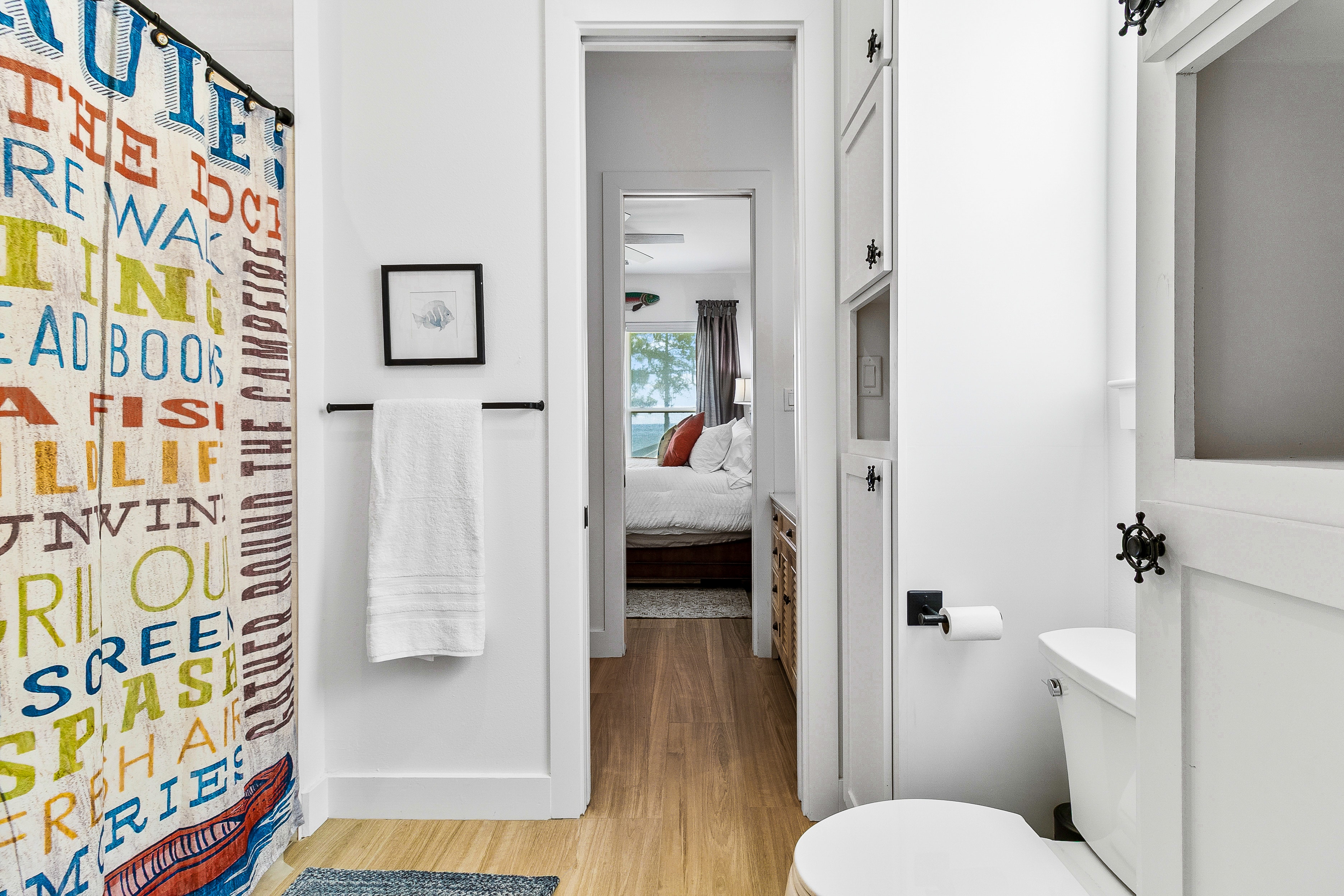 Bathroom with coastal bedroom view