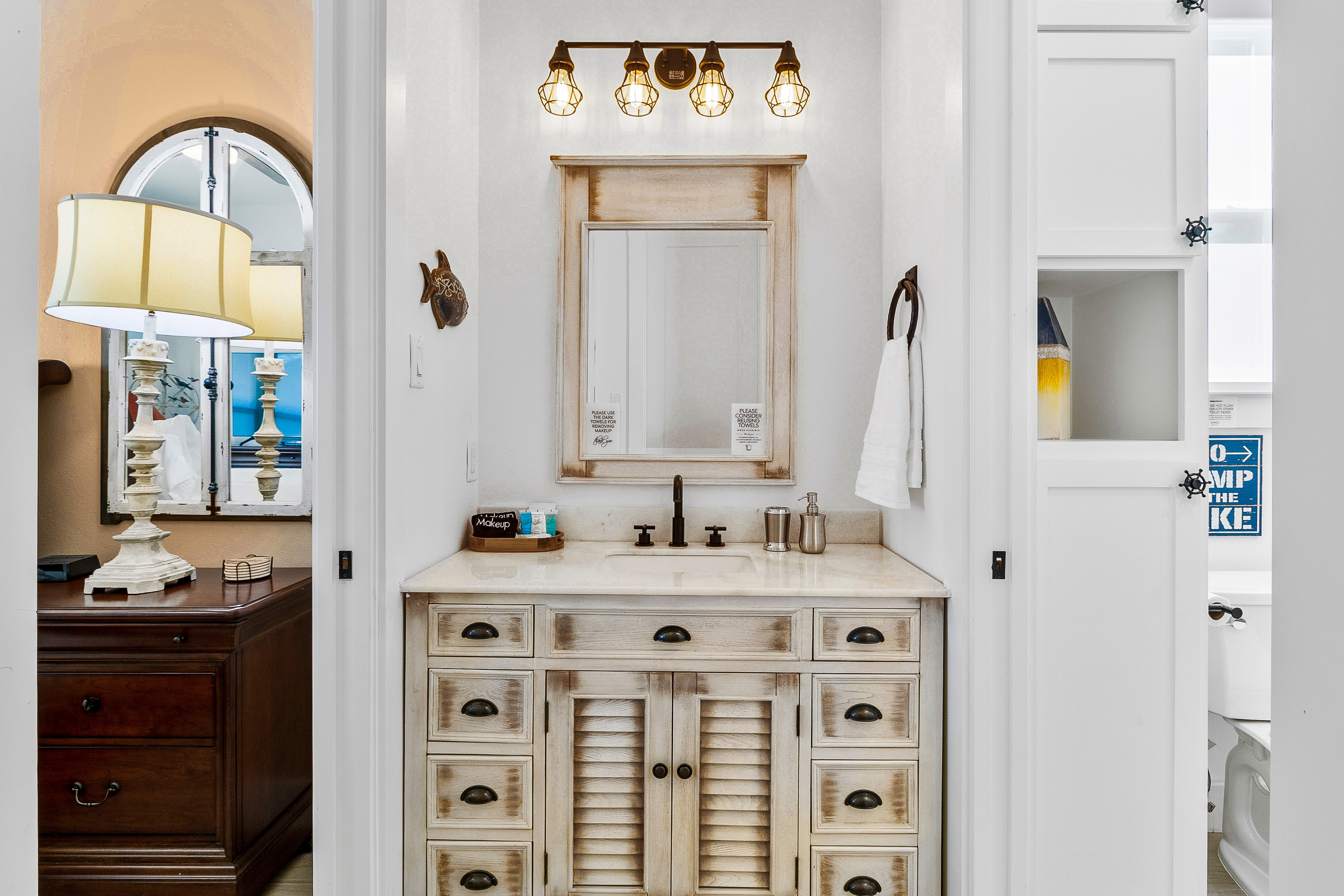 Bathroom vanity with brass fixtures and mirror