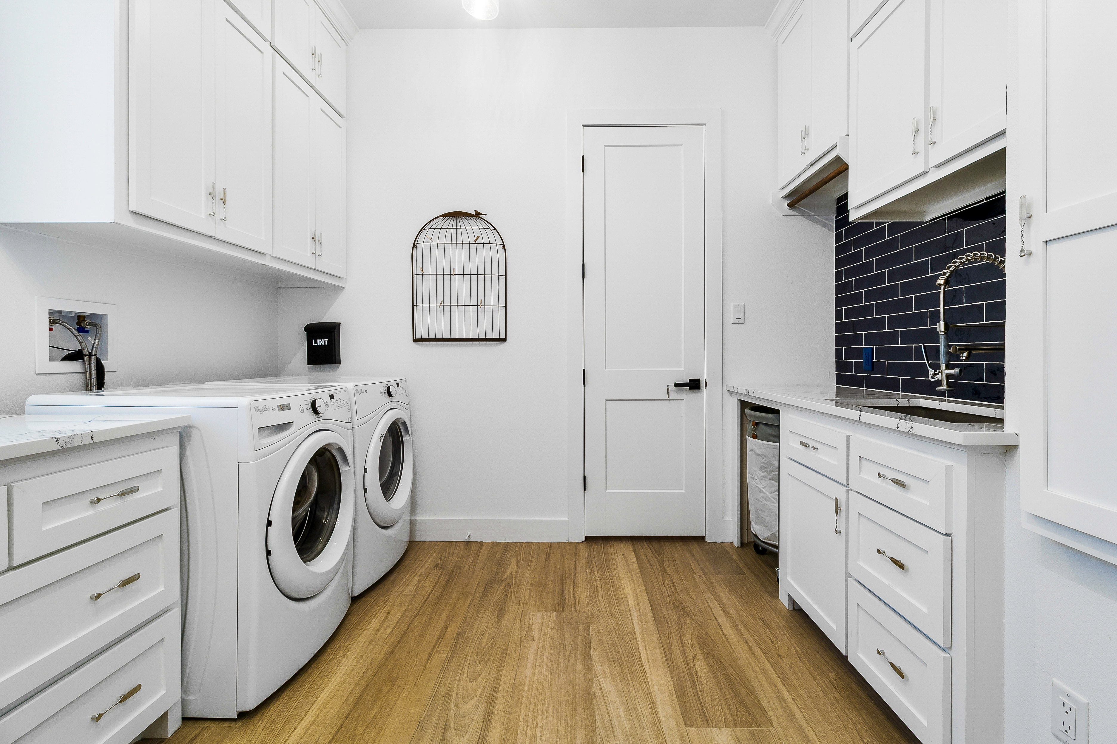 Modern white laundry room with washer and dryer