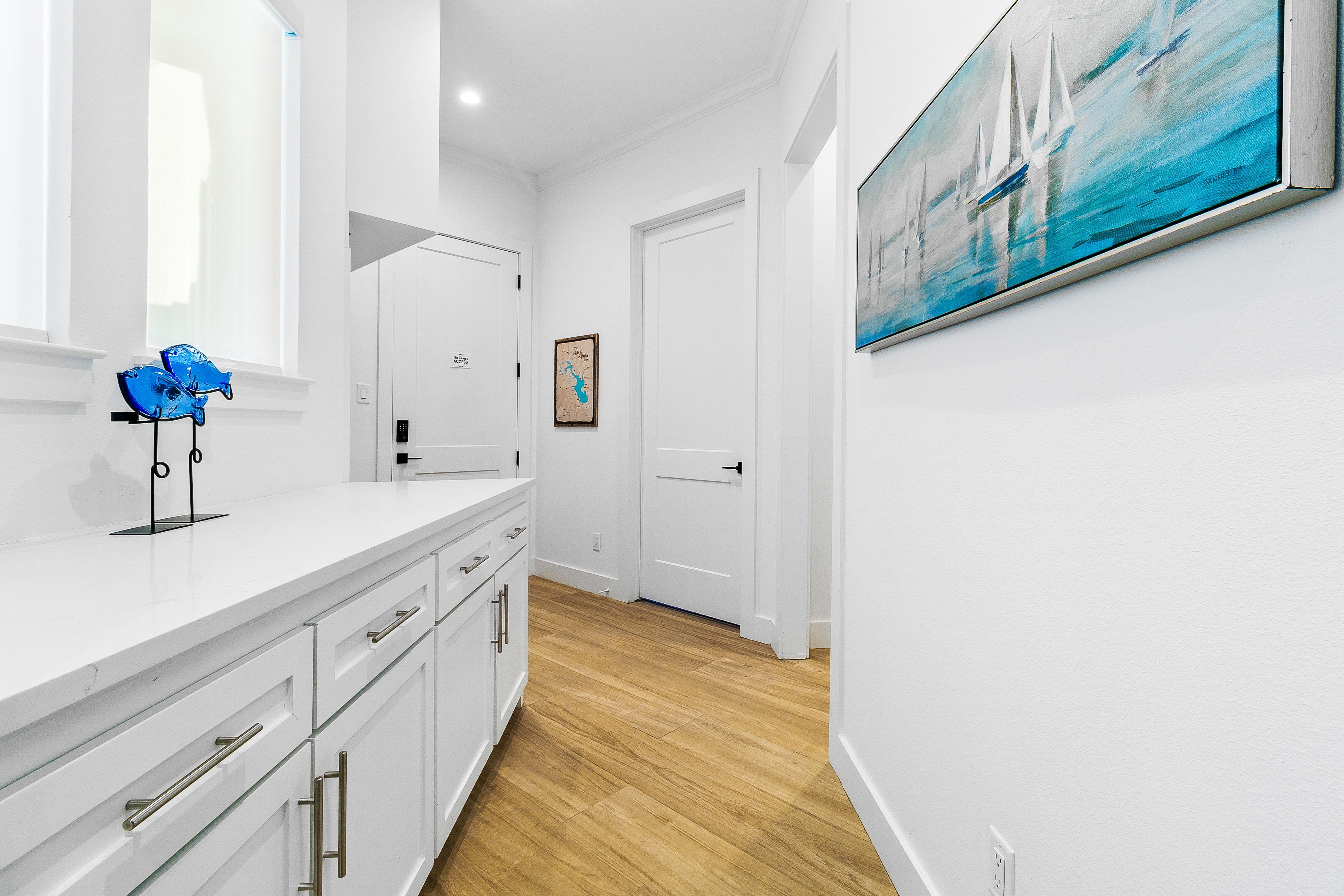 Modern white bathroom with blue artwork