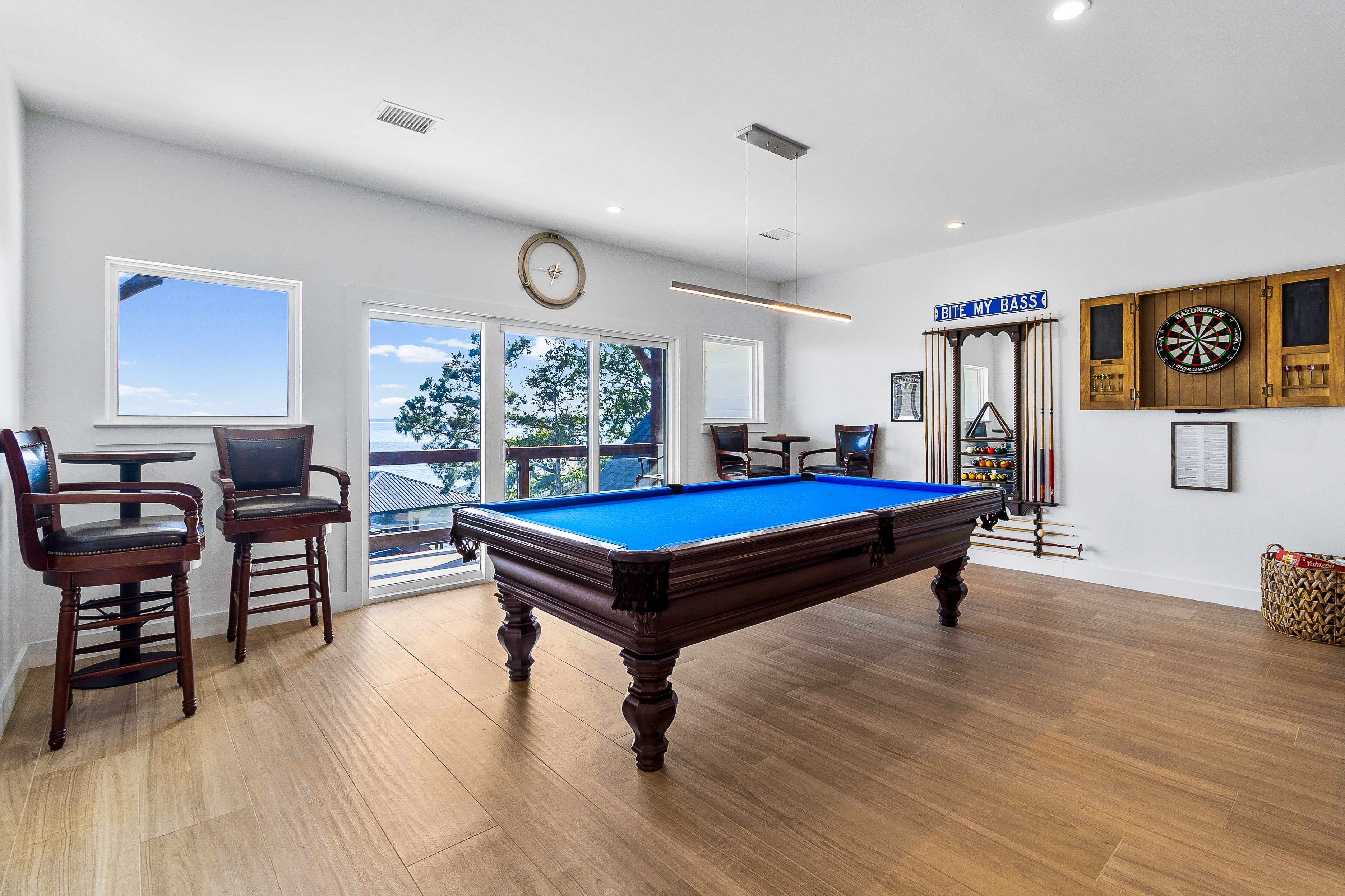 Luxury game room with pool table and lake view