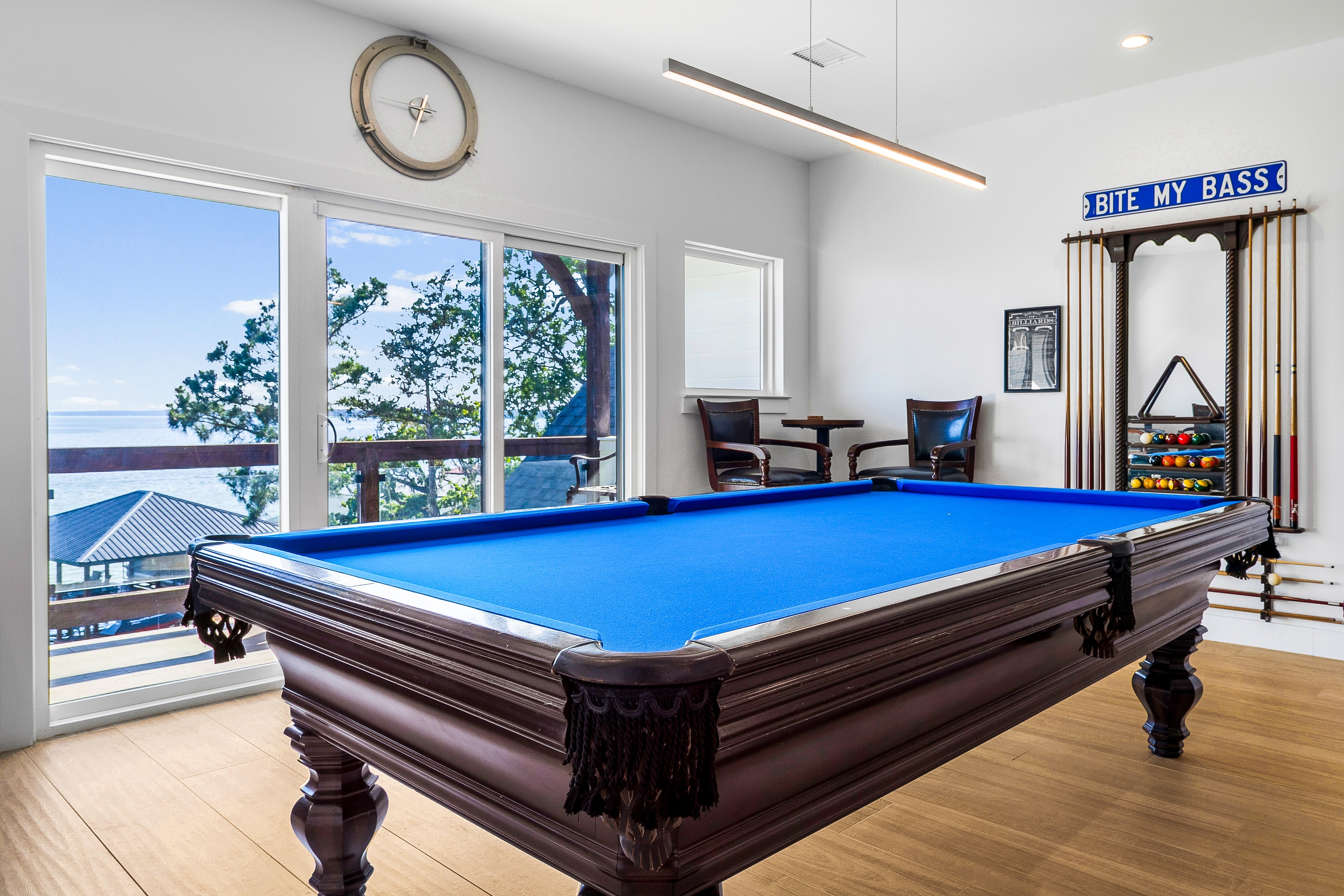 Modern game room with pool table and lake view