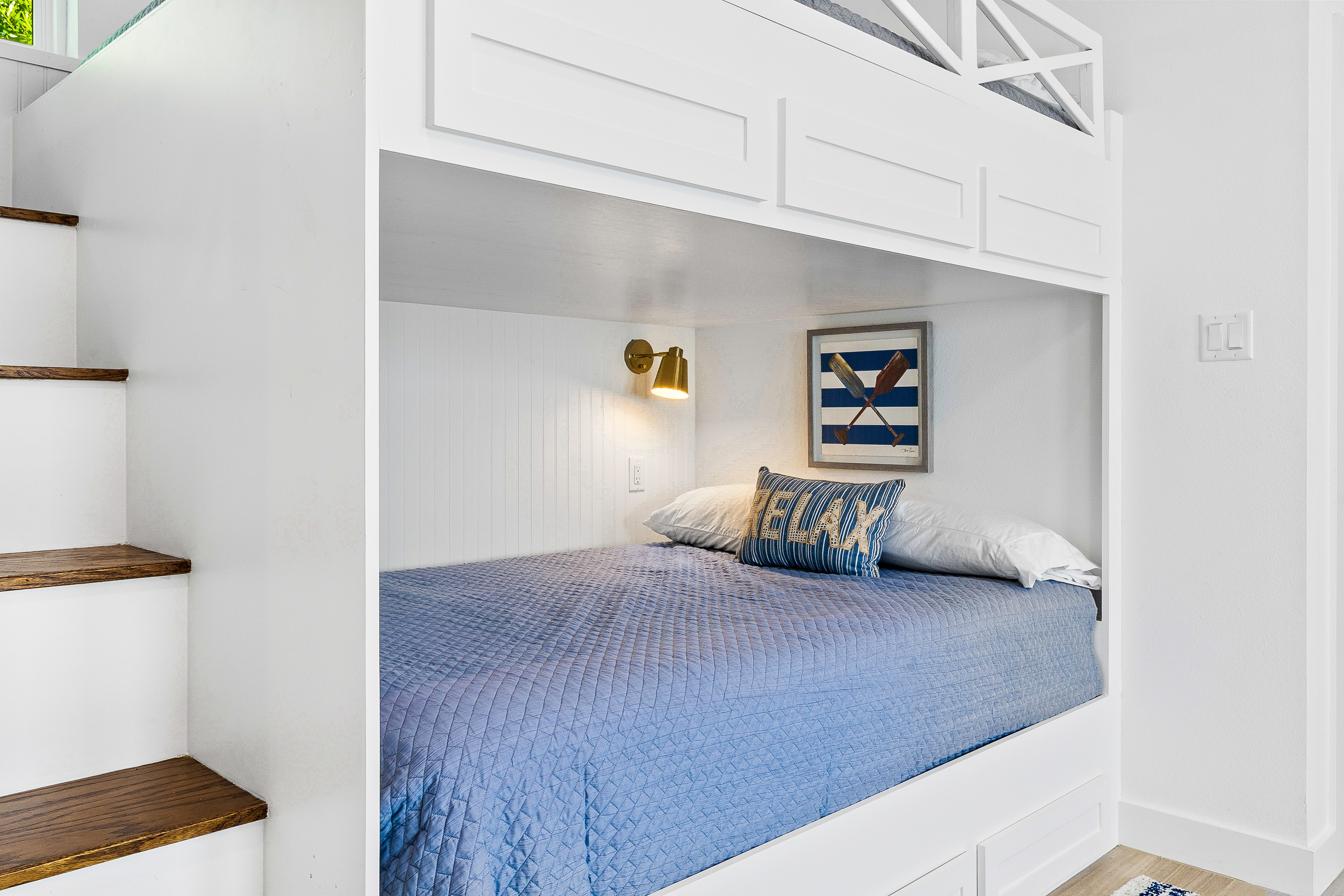 Loft bedroom with blue bedding and nautical decor