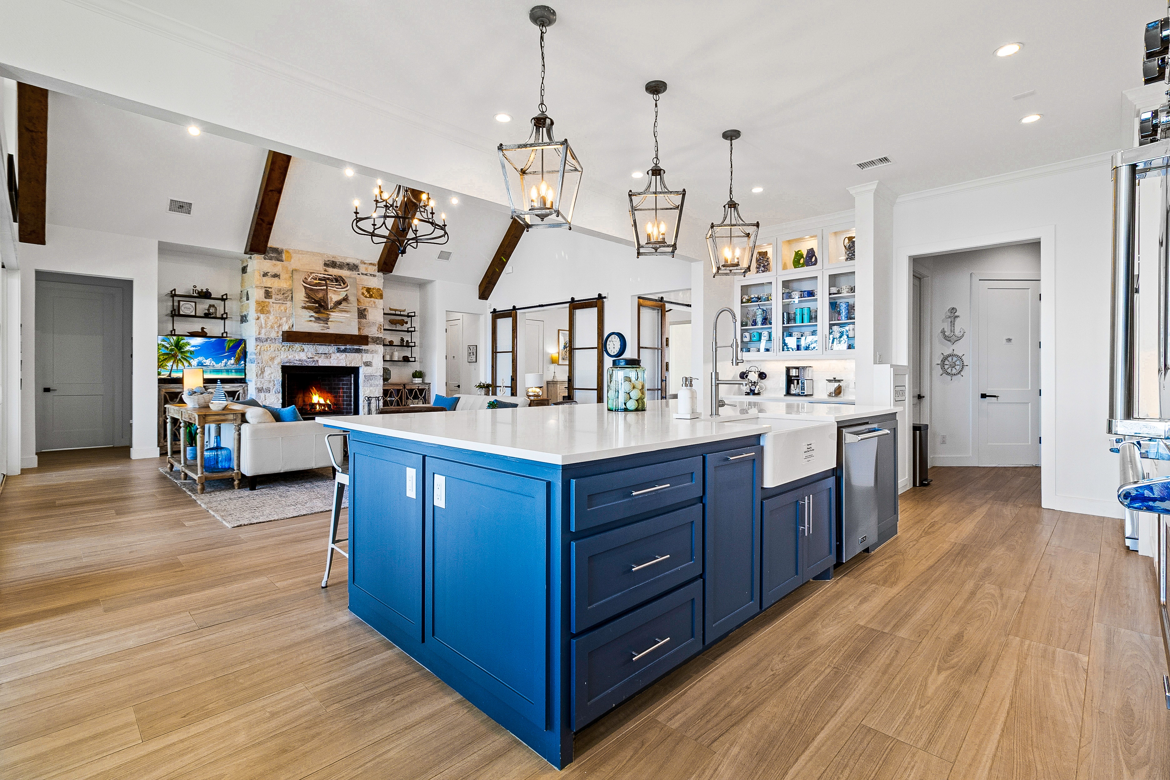 Kitchen with blue island and open living space