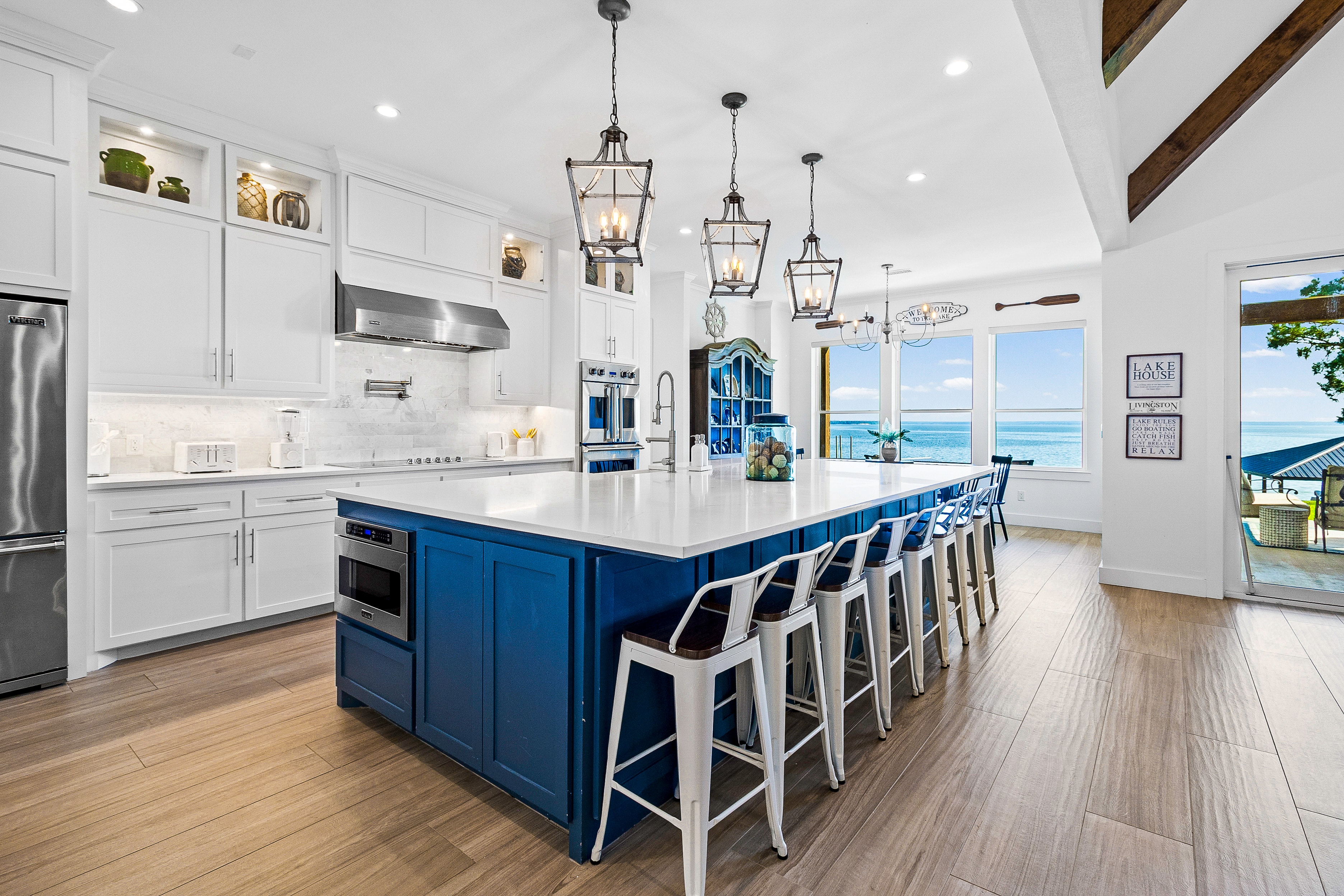 Coastal kitchen with blue island and lake view