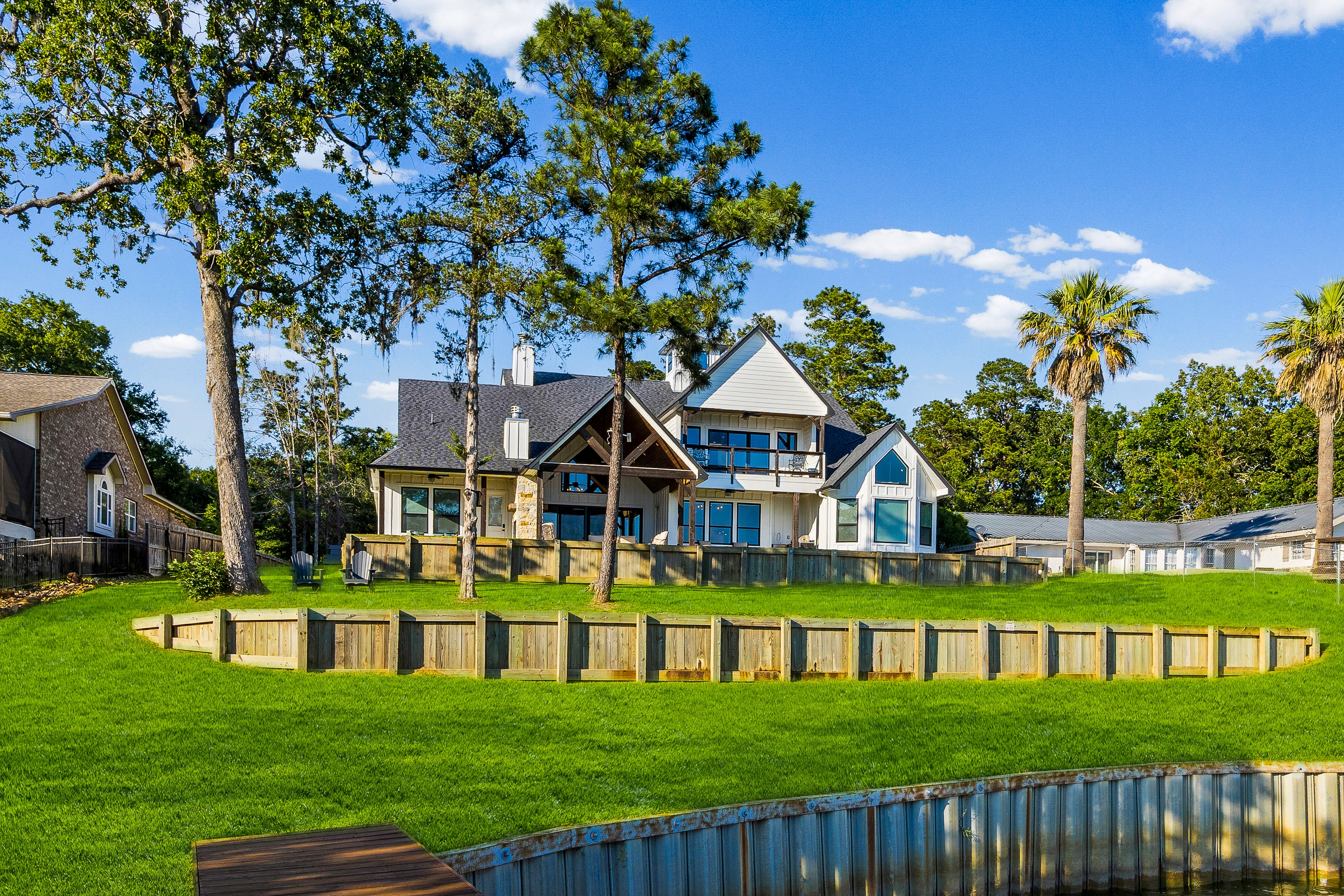 Modern farmhouse with waterfront lawn