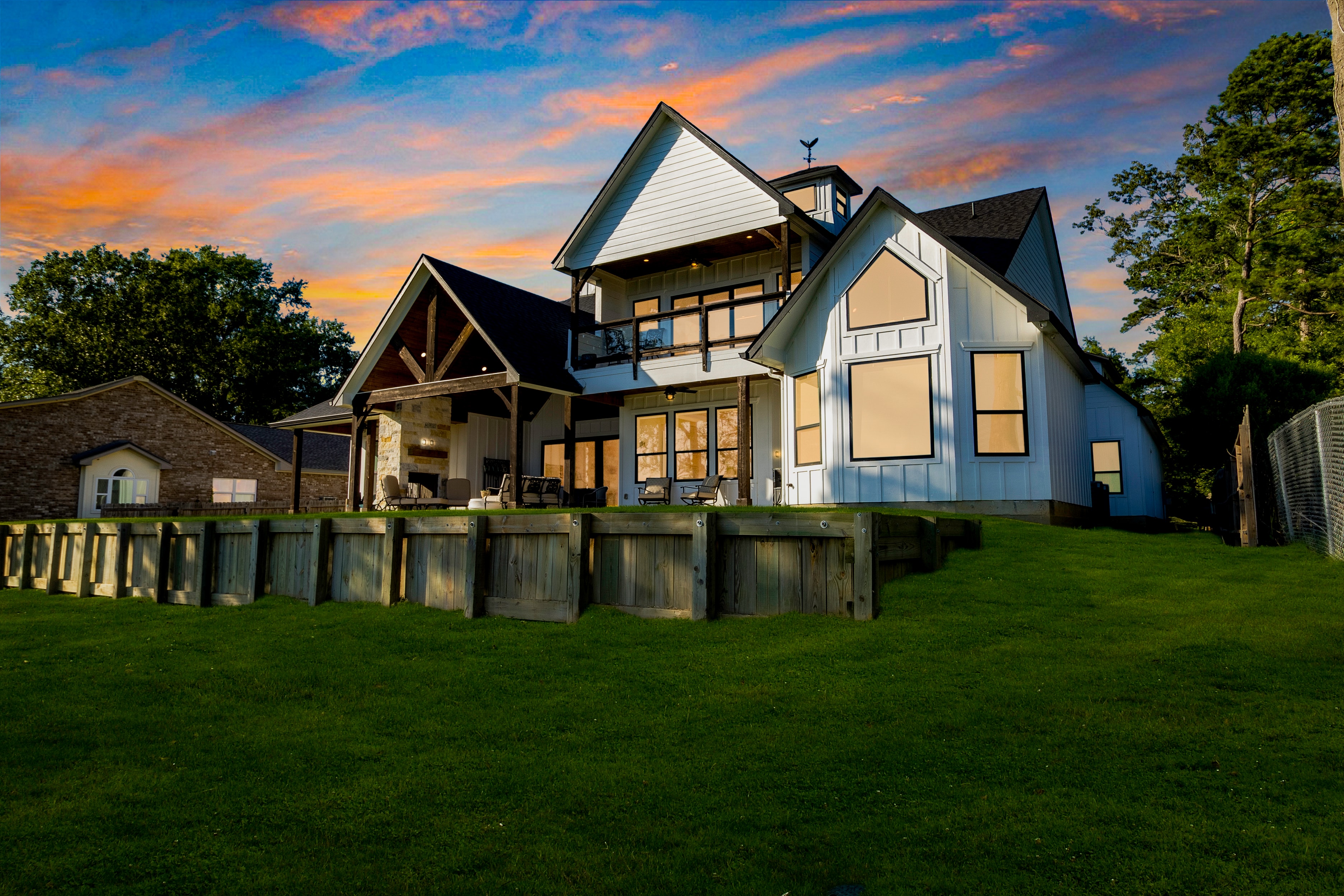 Lake house exterior with waterfront lawn
