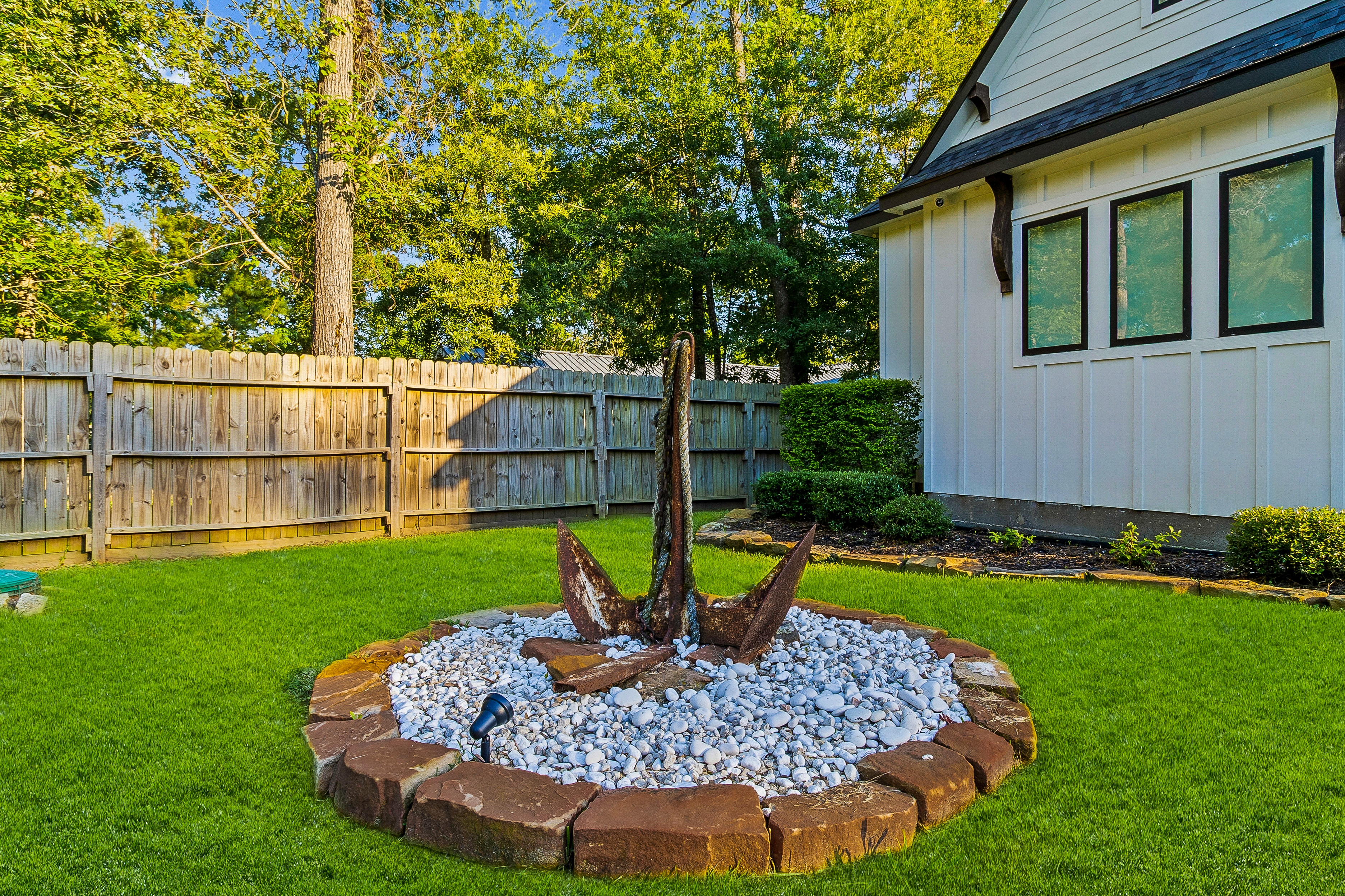 Backyard fire pit with anchor sculpture