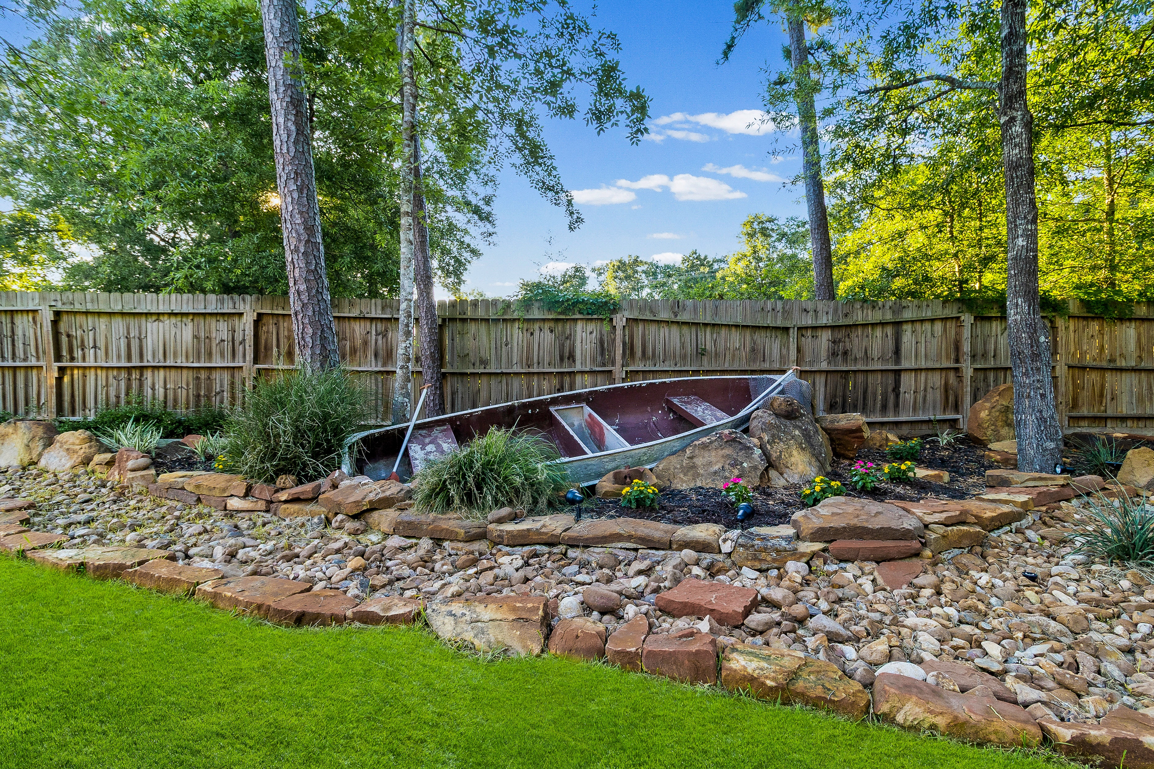 Rustic boat garden display in backyard