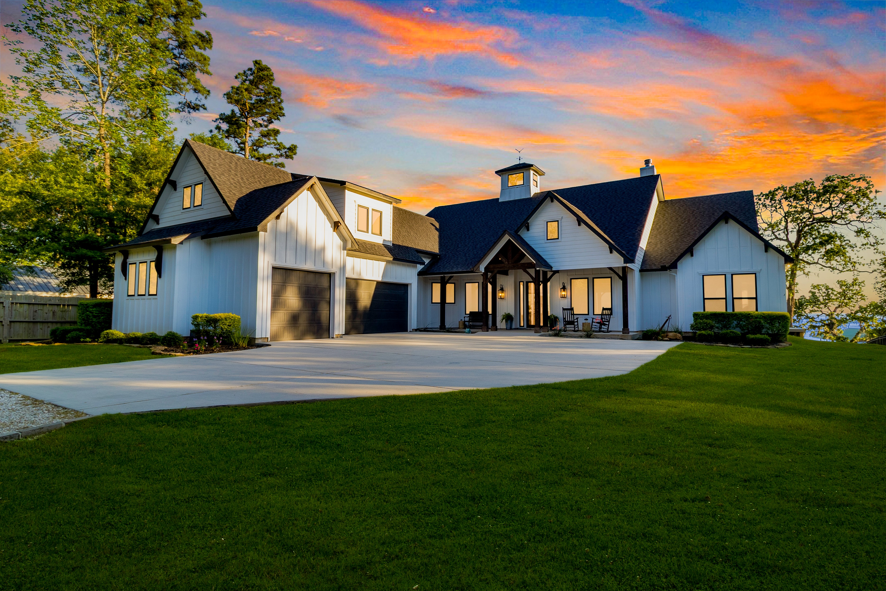 Lake house exterior with dramatic sunset sky