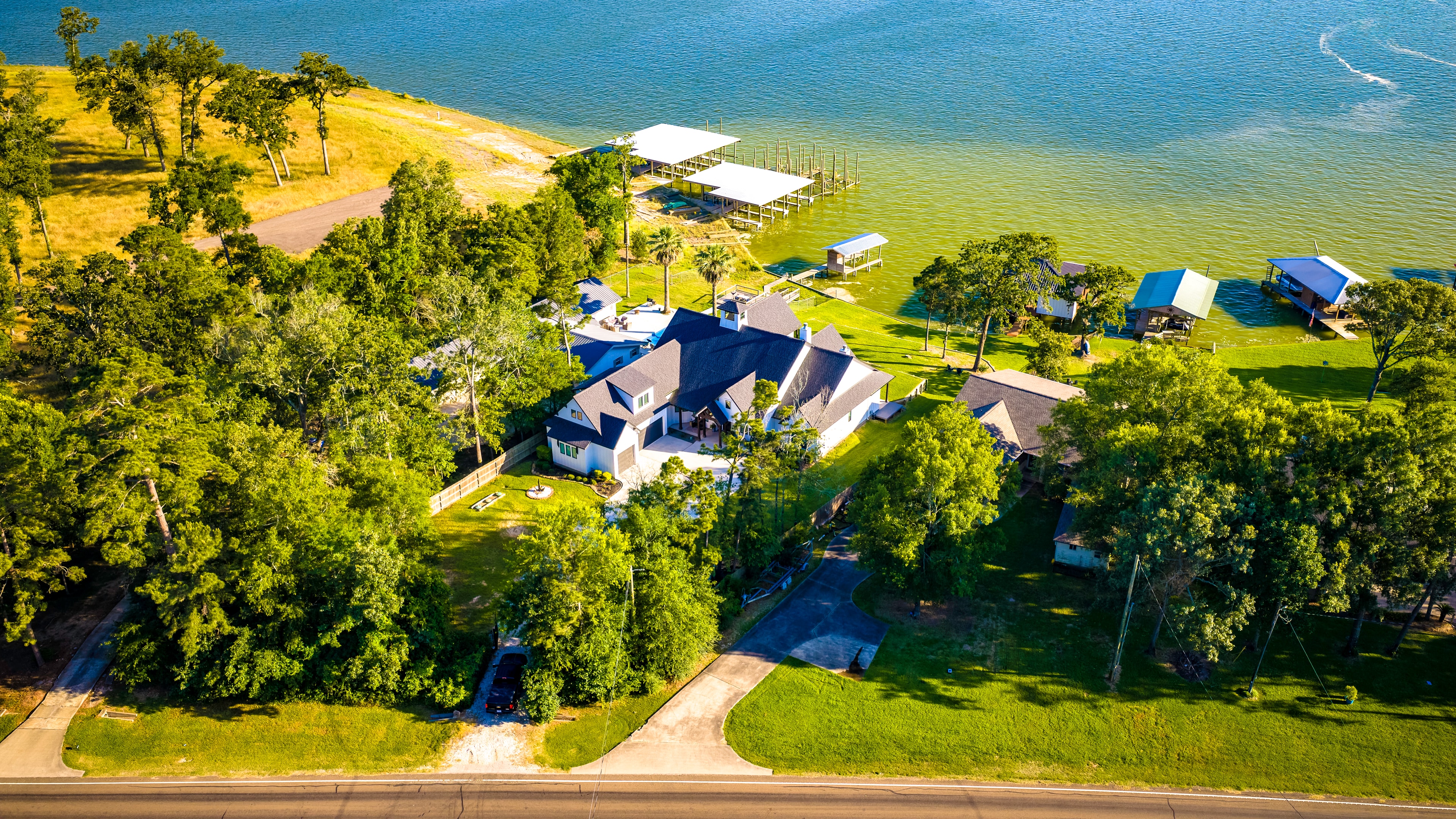 Aerial drone view of lake house and shoreline